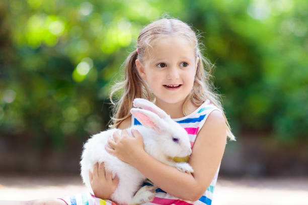 istock Child with rabbit. Easter bunny. Kids and pets. 1132848045