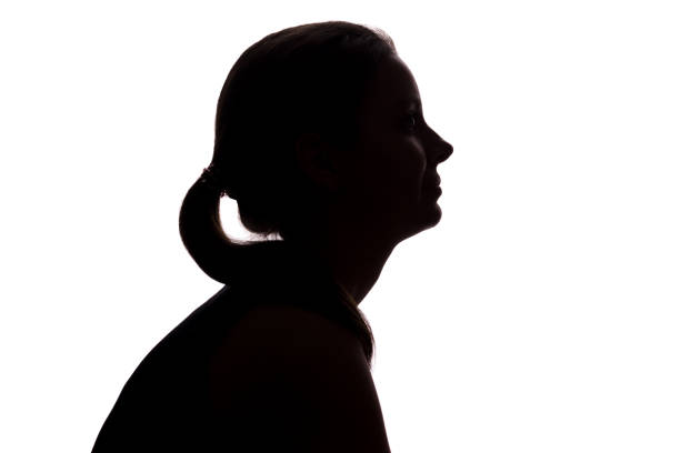 istock Young woman looking up - horizontal silhouette 1132848878