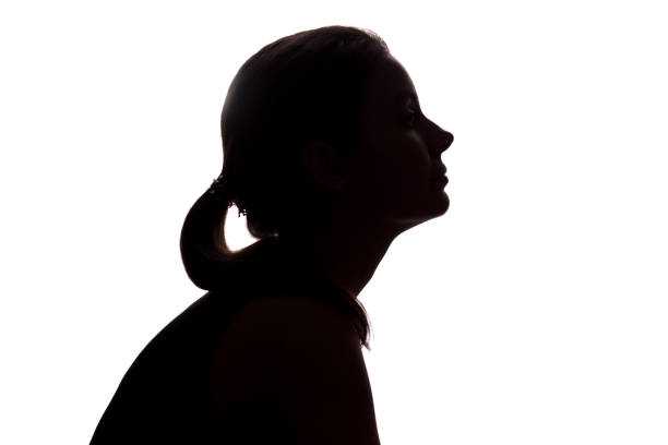 istock Young woman looking up - horizontal silhouette 1132849249