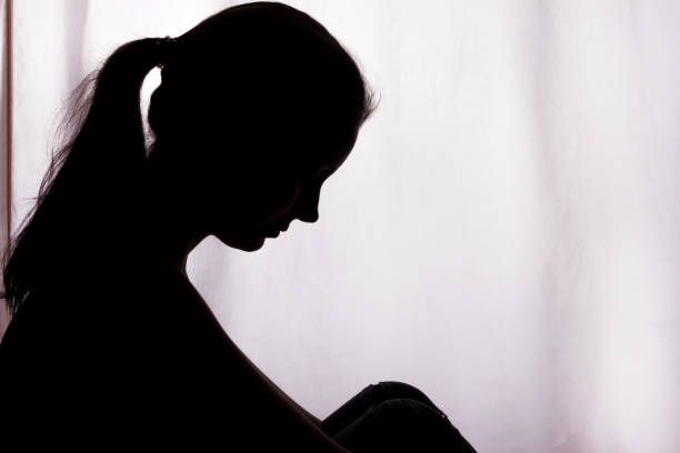 Silhouette of a young woman with problems Silhouette of a young woman with problems - horizontal, isolated woman alone dark shadow stock pictures, royalty-free photos & images