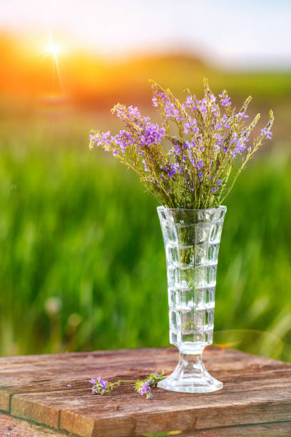 lilac bouquet in a vase on a wooden table