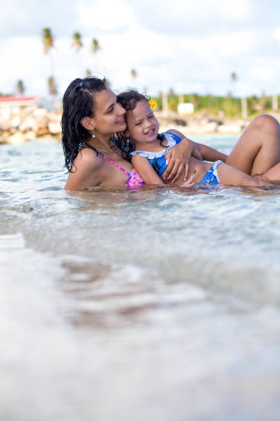 istock Happy mom and daughter on the beach 1132849944