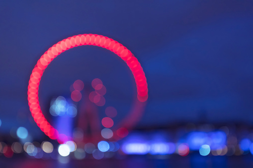 Blurred ferris wheel and bokeh background. City view at night.