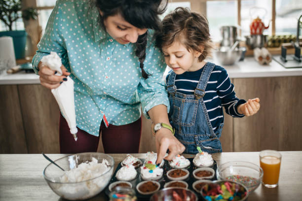 istock Mom and son making muffins 1132850400
