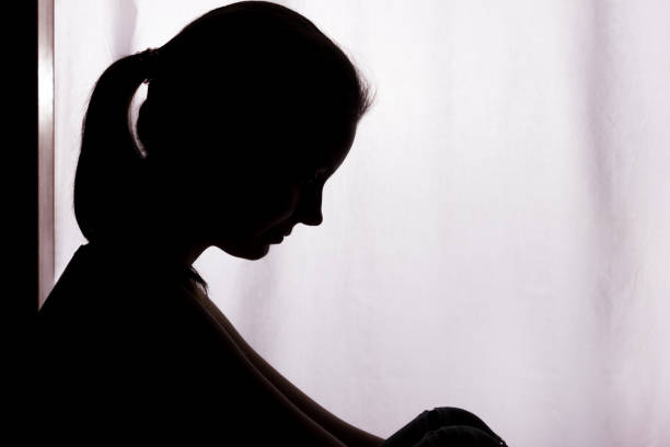 istock Silhouette of a young woman with problems 1132850415