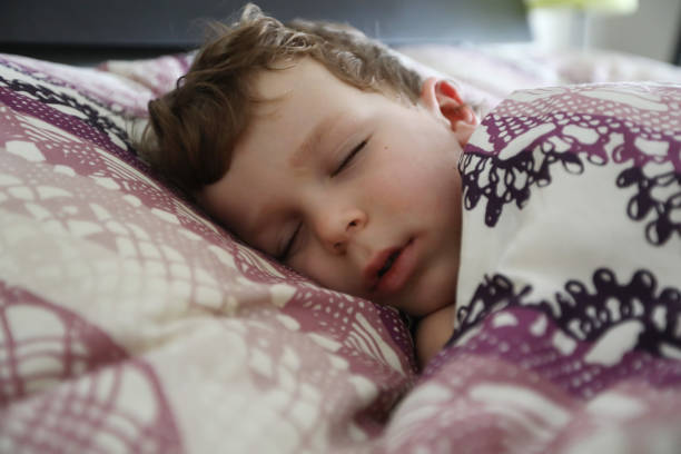 istock Little boy sleeping in a big bed 1132852917