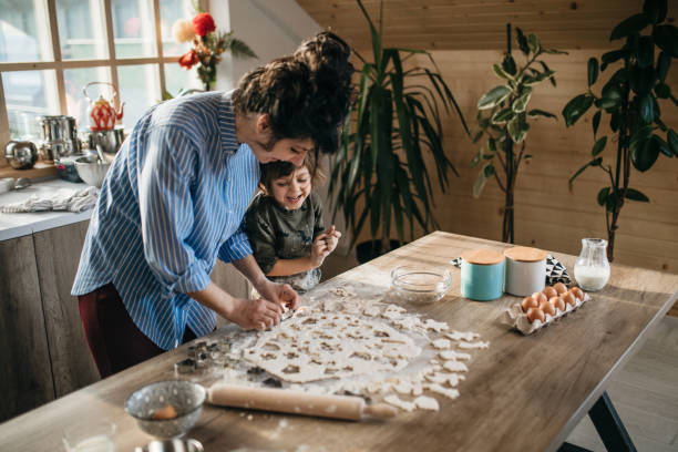 istock Mom and son preparing cookies 1132853756