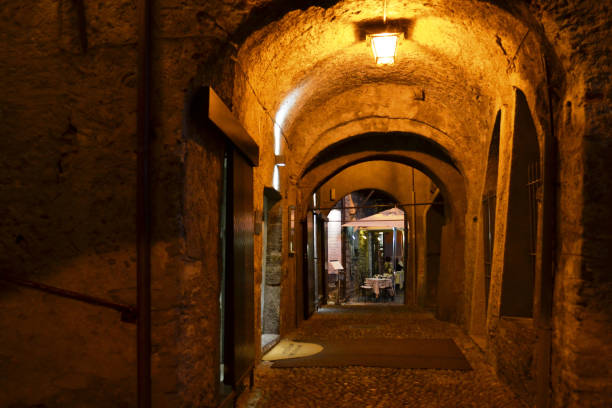 Close-up view to a beautiful ancient gallery brightly illuminated in the darkness with a vintage lamp.