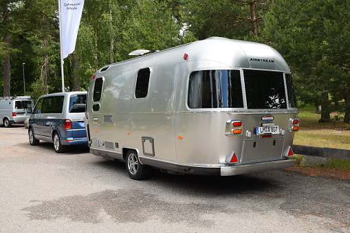Scania, Sweden - June, 25th, 2015: Volkswagen T6 Multivan with camper trailer stopped on the road. This model is often used in families and businesses journeys in Europe.