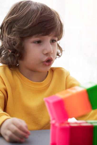 istock Beautiful boy playing in the playroom with educational toy blocks. 1132858728