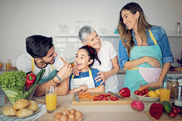 istock Happy family is cooking together in kitchen 1132858989