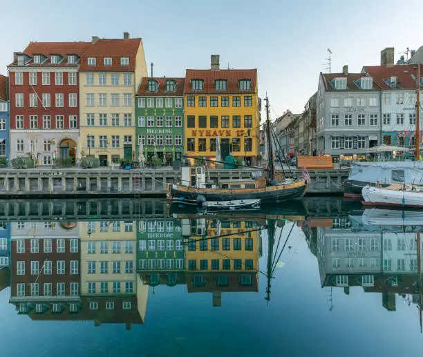 Reflections of colourful houses and sailingboats in the calm canal of wonderful Copenhagen, February 16, 2019