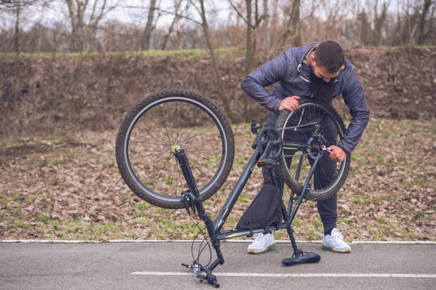 istock man repairing a bicycle 1132863450