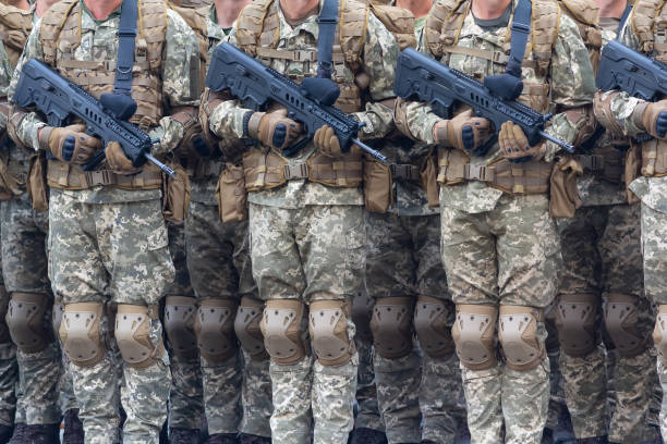 istock Soldiers with automatic rifles in the ranks. Armament 1132863723