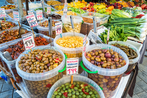 Stock photograph of food market stall with pickled olives and vegetables in old town Granada Andalusia Spain