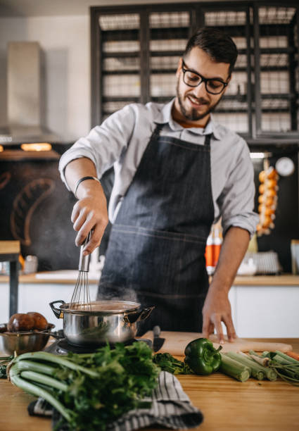 istock Man mixing food 1132867515