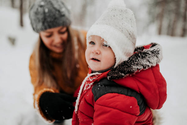 istock Mother pushing her son on sled 1132870074