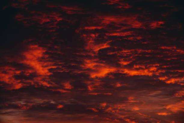 istock Fiery red blood vampire dawn. Amazing warm dramatic fire cloudy sky. Vivid orange sunlight. Atmospheric background of sunrise in overcast weather. Hard cloudiness. Storm clouds warning. Copy space. 1132874484