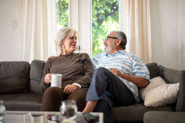 istock Senior couple sitting on the sofa and drinking tea 1132874518