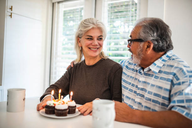 istock Senior couple celebrating a birthday with muffins 1132874523