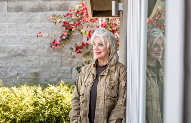 istock Senior woman standing outside and smiling 1132874548