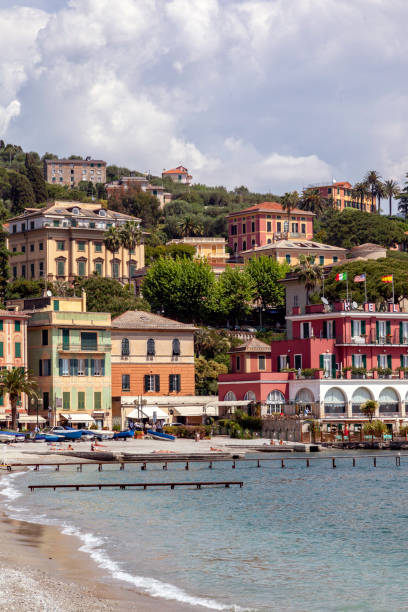 Sunning on the Beach next to restaurants and hotels in Santa Margherita Ligure Sunning on the Beach next to restaurants and hotels in Santa Margherita Ligure santa margherita ligure italy stock pictures, royalty-free photos & images