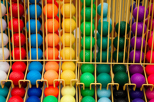 Colorful Putt Putt Mini Golf Balls in Dividing Rack