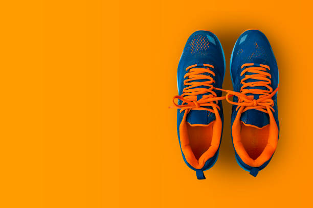 istock Sport shoes isolated on yellow background. 1132885647