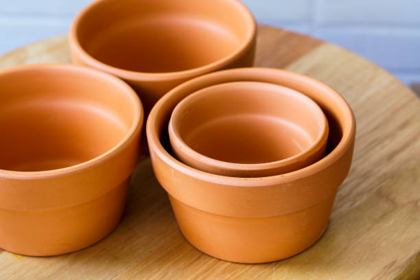 istock Empty rough ceramic brown flower pot isolated on white background 1132885750