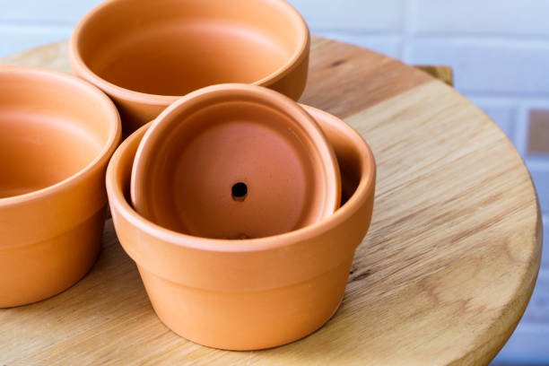 istock Empty rough ceramic brown flower pot isolated on white background 1132885755
