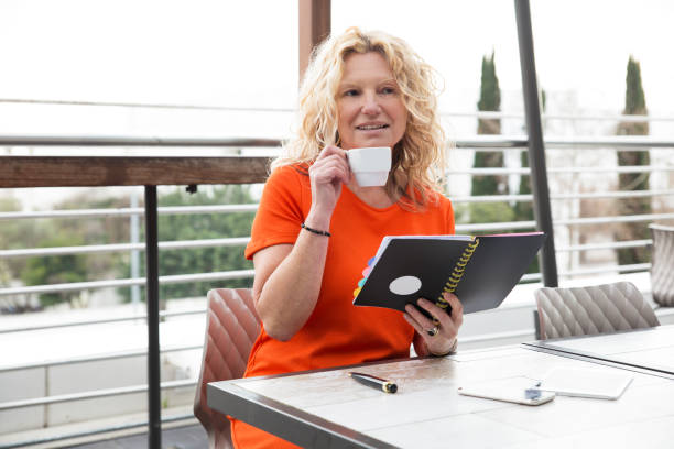 istock Smiling pensive lady studying daily planner 1132887568