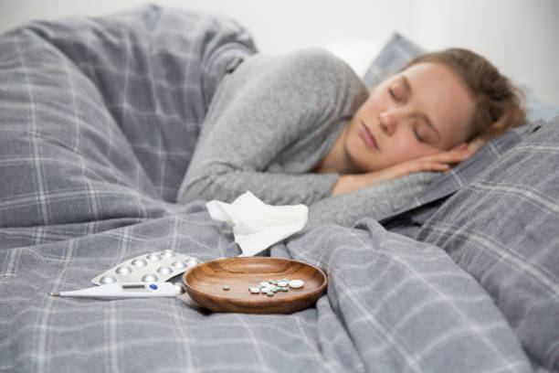 istock Sick young woman lying in bed, having rest 1132888741