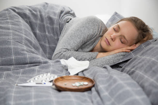 istock Sick young woman lying in bed, sleeping 1132888744