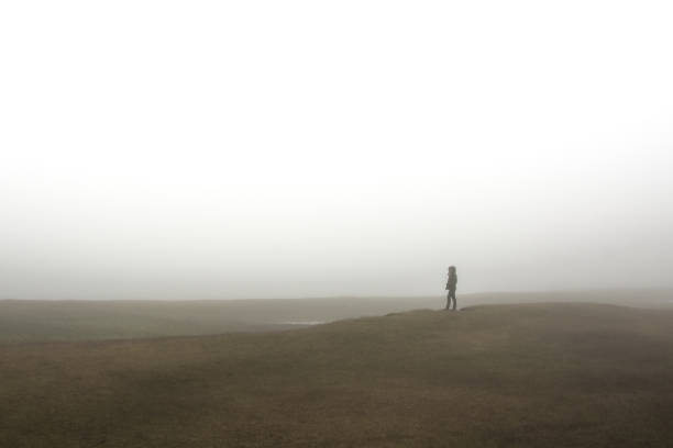 Silhouette of walker inside the fog.