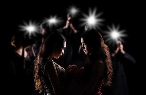 Portrait of Two Miss Asian Women Pageant Beauty Contest in Evening Ball Gown dress, look waiting final announcement moment, surround with media photographer, low key exposure silhouette copy space