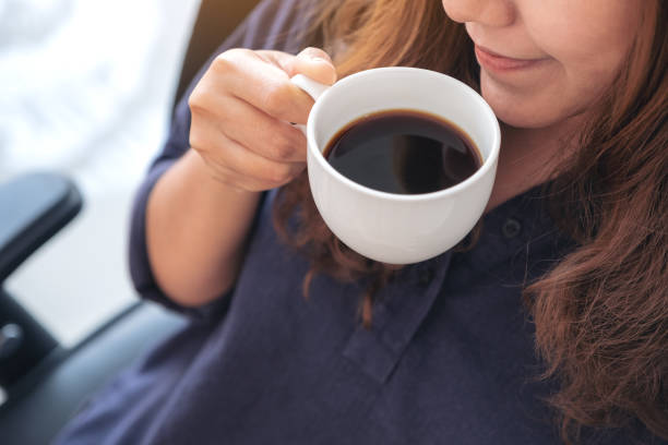 istock woman holding and drinking hot coffee with feeling good 1132889709