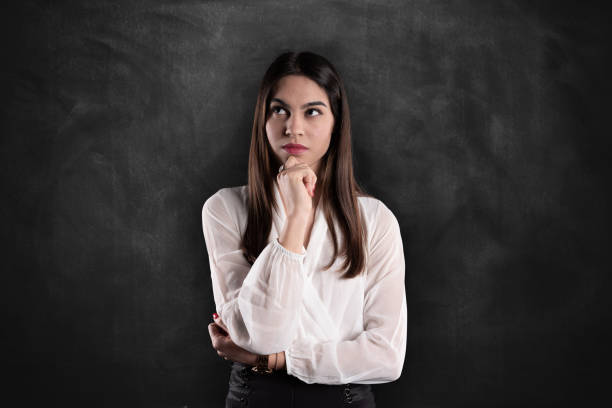 istock Business woman on blackboard thinking 1132892503