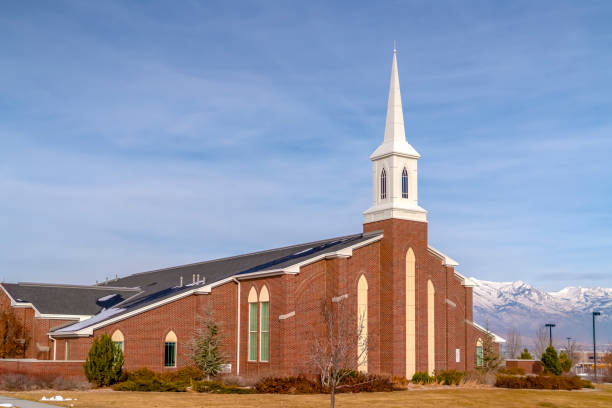 istock Church against snow capped mountain and cloudy sky 1132892669