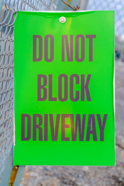 istock Do Not Block Driveway sign on a mesh wire fence 1132892705