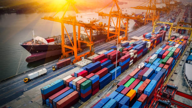 istock Logistics and transportation of Container Cargo ship and Cargo plane with working crane bridge in shipyard at sunrise, logistic import export and transport industry background 1132894998