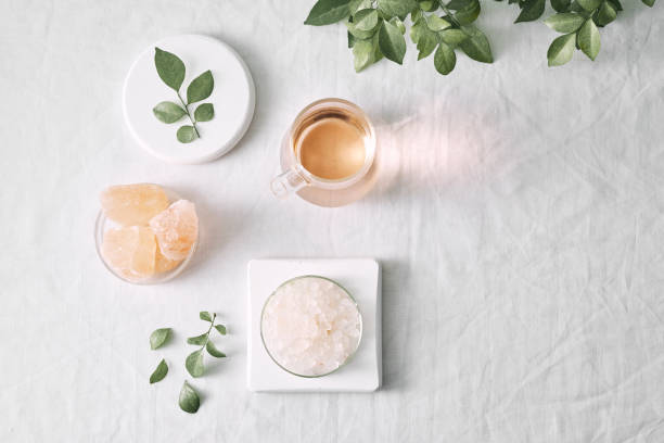 istock Aromatherapy. Small glass bottles with cosmetic oils. Bath salt. Fresh leaf. Objects for spa procedures on white background oil, leaf. 1132897007
