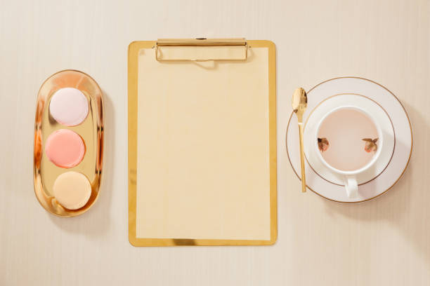 istock Women's home office workspace with clipboard, macaroons, pen, coffee mug on pastel background. Flat lay, top view lifestyle concept. 1132899952