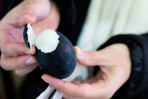 istock Egg Black , people hold boiled black egg with two hands and peel , Black egg from hot springs Owakudani, Hakone, in Japan. 1132901056
