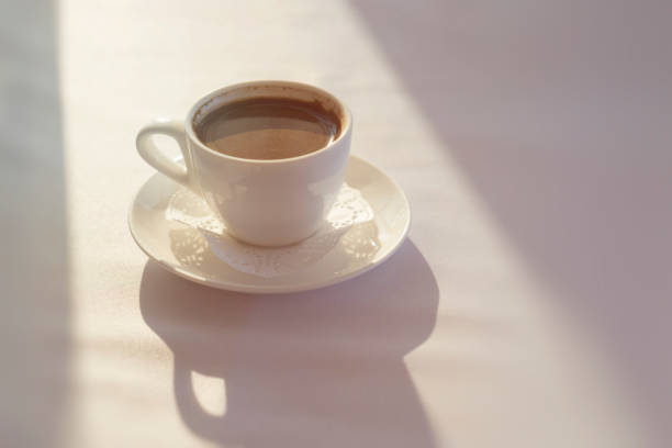 istock White Cup with black Turkish coffee on white tablecloth 1132905286