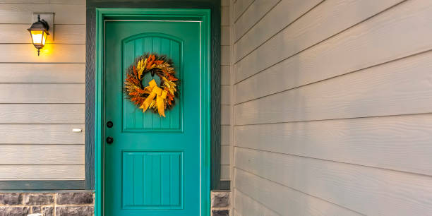 istock Home entrance with wreath on blue green front door 1132906839