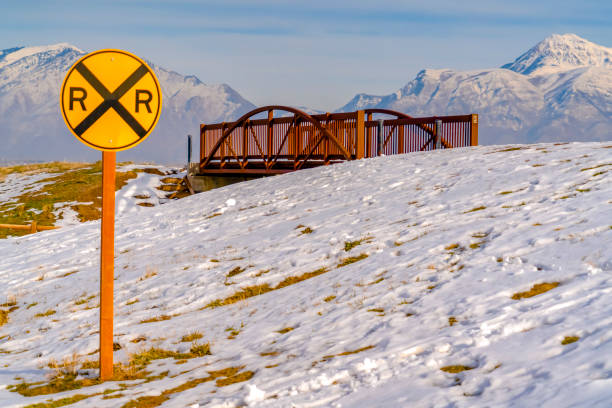 istock Railway sign against a bridge and snowy mountain 1132906897