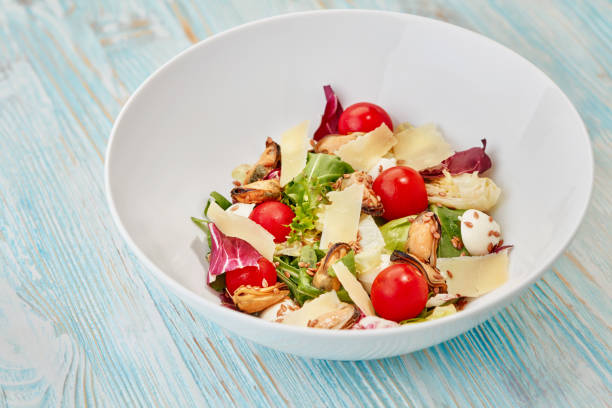 bowl of fresh salad on blue wooden table