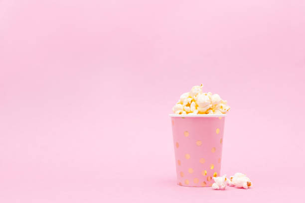 istock cup of tasty popcorn on a pink background 1132915498