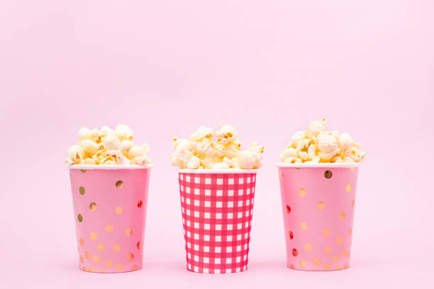 istock several cups of popcorn on a pink background 1132915499