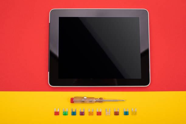 Set of electrical tool and black tablet on colorful background Accessories for engineering work. Toolkit of electrician on tableware and black tablet make over series stock pictures, royalty-free photos & images